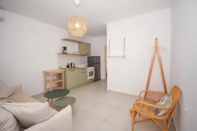 a living room with a couch and a kitchen at Elia Apartments in Falasarna
