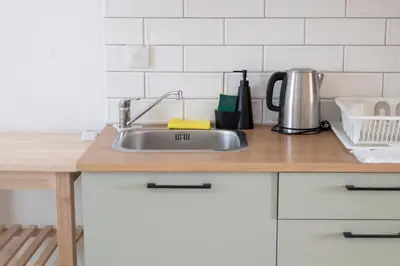 a kitchen counter with a stainless steel sink at Elia Apartments in Falasarna