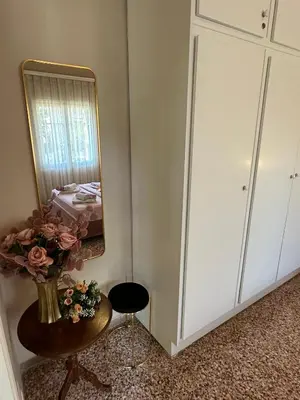 a room with a mirror and a chair and a table at ANMI Hospitality in Chania Town