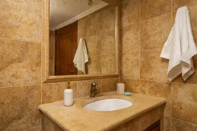 a bathroom with a sink and a mirror at Agnadia Villa in Stalos