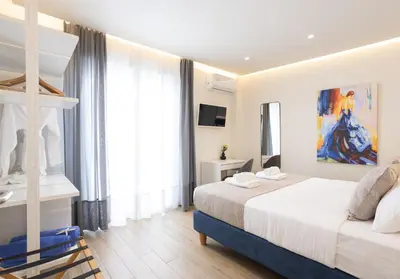 a bedroom with two beds and a large window at Chania Memories in Chania Town