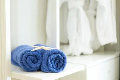 a pile of towels sitting on a shelf in a bathroom at Chania Memories in Chania Town
