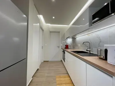 a kitchen with white cabinets and a sink at Chania Memories in Chania Town