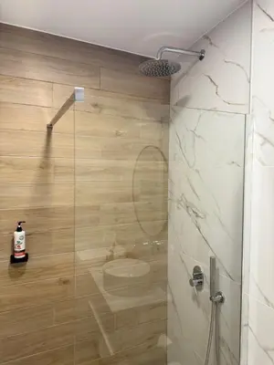 a bathroom with a shower with a glass door at Chania Memories in Chania Town