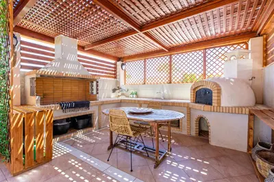 a large kitchen with a table and an oven at Gold Crest Home in Drapanias beach, Nopigia in Kissamos