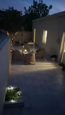 a patio with a table and chairs at night at Hygge Home Chania in Chania Town