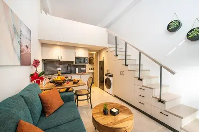 a living room with a green couch and a table at Ontas apartment in Kissamos in Kissamos