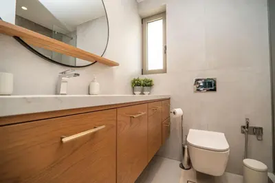 a bathroom with a toilet and a sink and a mirror at Cozy Spot II near the beach in Ayiá
