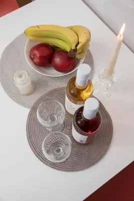 a table with a plate of fruit and a candle at Vesta suite&studio in Chania Old Town in Chania Town