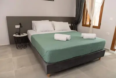 a bedroom with a bed with two pillows on it at Vesta suite&studio in Chania Old Town in Chania Town